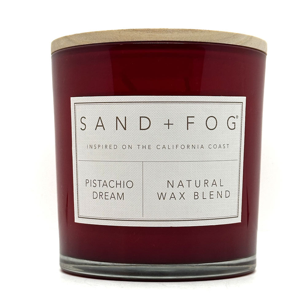 Pistachio Dream candle with a label reading 'Sand + Fog' on a white background