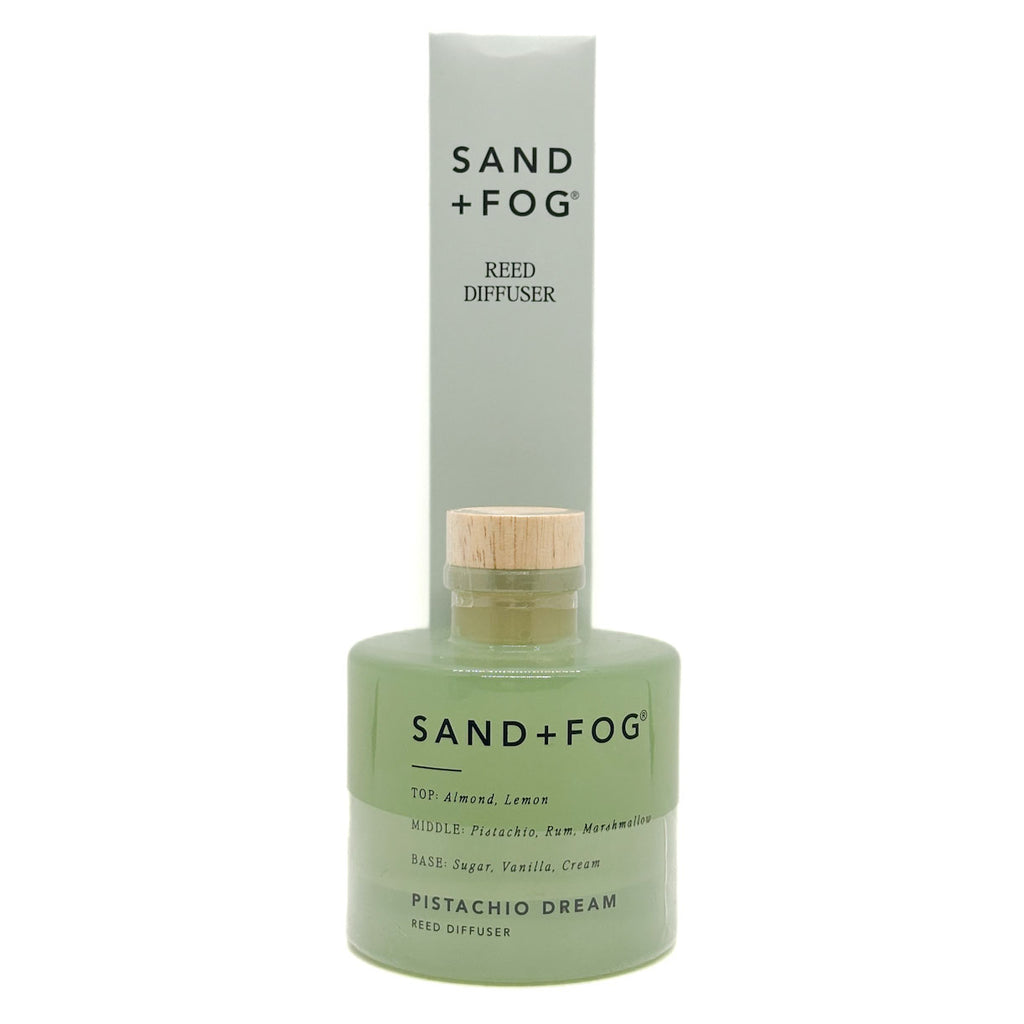 Sand + Fog Pistachio Dream reed diffuser with green bottle and wooden cap on a white background
