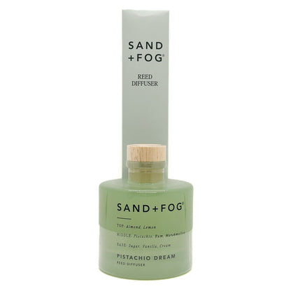 Sand + Fog Pistachio Dream reed diffuser with green bottle and wooden cap on a white background