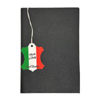 Black leather notebook with a 'Made in Italy' tag featuring Italian flag colors.