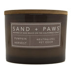 Pumpkin Harvest candle with 'Sand + Paws' label on a white background