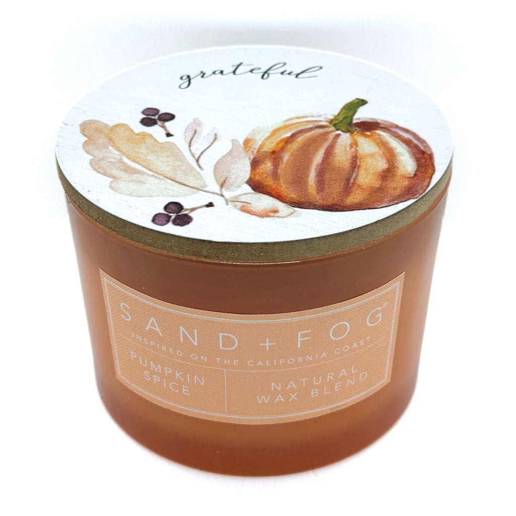 SAND + FOG Candle with a pumpkin spice label on a white background