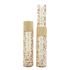 SAND + FOG Pumpkin Spice Room Spray & Reed Diffuser floral-patterned bottles with wooden caps on a white background