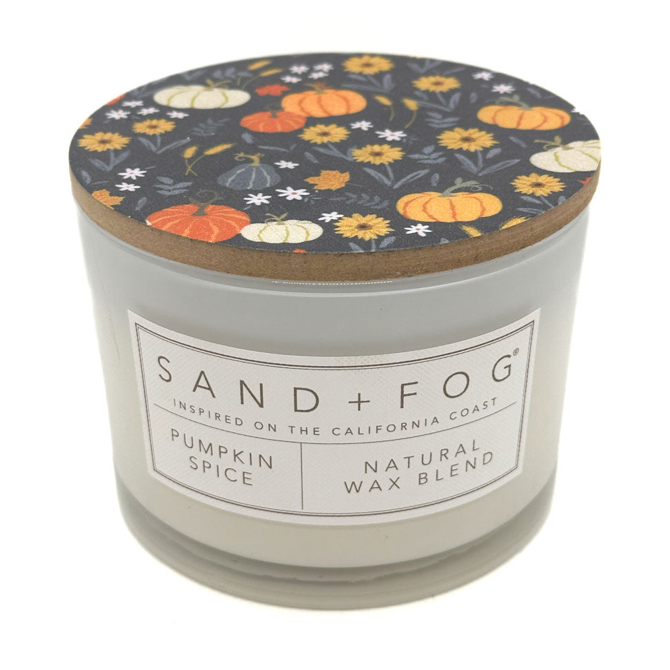 Pumpkin Spice Candle with a decorative lid featuring pumpkins and flowers, branded 'Sand + Fog'.