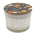 Pumpkin Spice Candle with a decorative lid featuring pumpkins and flowers, branded 'Sand + Fog'.