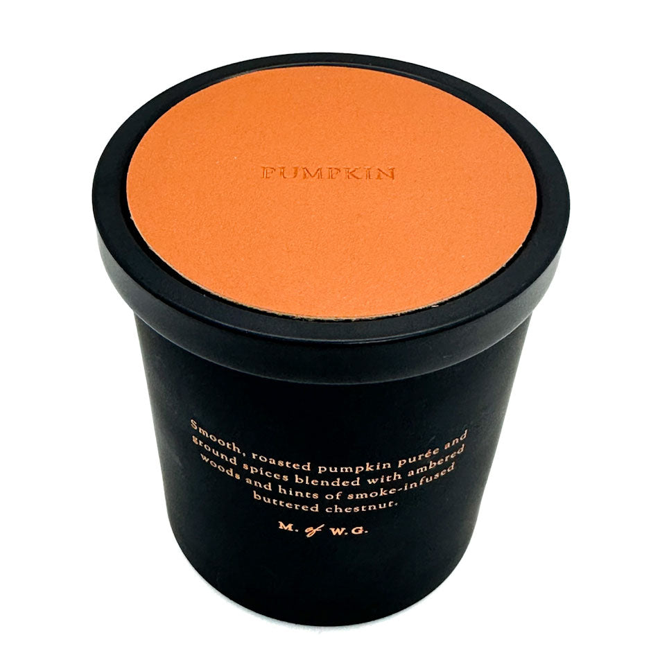 Black container with orange lid labeled 'Pumpkin' on a white background
