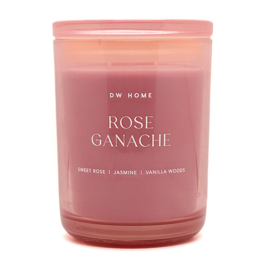 Pink candle labeled 'Rose Ganache' by DW Home on a white background