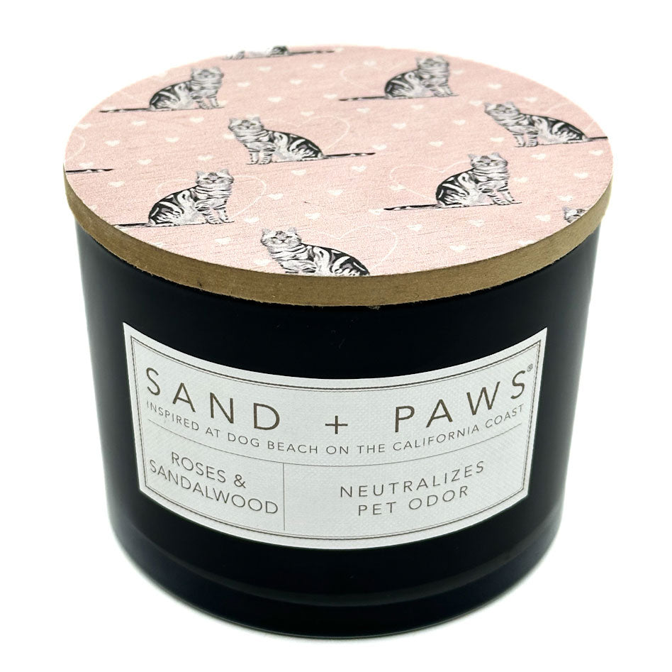 Roses & Sandalwood Candle with 'Sand + Paws' label and cat pattern on lid