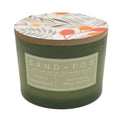 Roses & Sandalwood Green candle with floral lid labeled 'Sand + Fog' on a white background