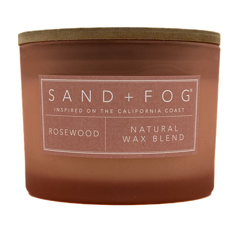 Rosewood rose candle with 'Sand + Fog' label on a white background