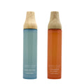 Two bottles of Sand + Fog linen spray with wooden nozzles on a white background.
