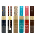 Collection of Sand + Fog reed diffuser bottles with various designs and colours on a white background.