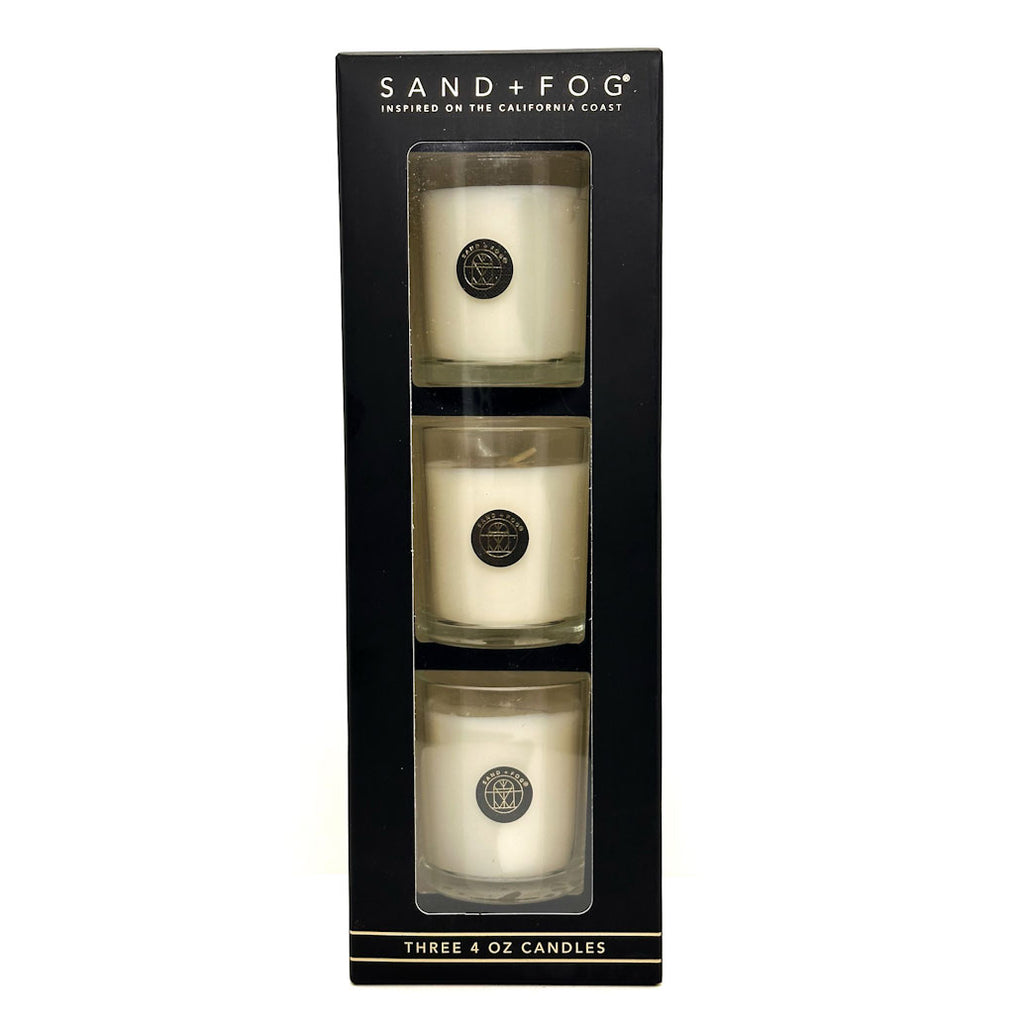 Three 4 oz candles in a black box with 'Sand + Fog' branding.