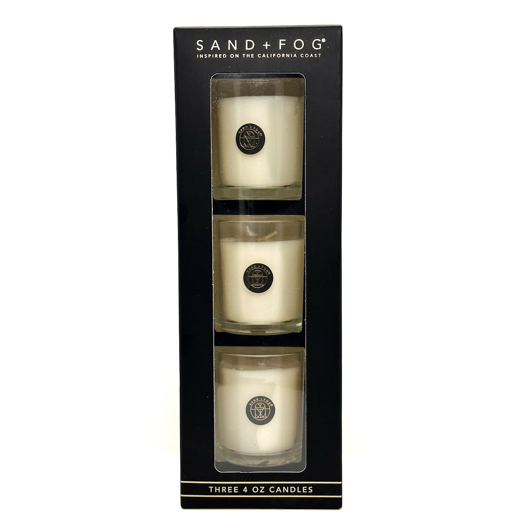 Three 4 oz candles in a black box with 'Sand + Fog' branding.