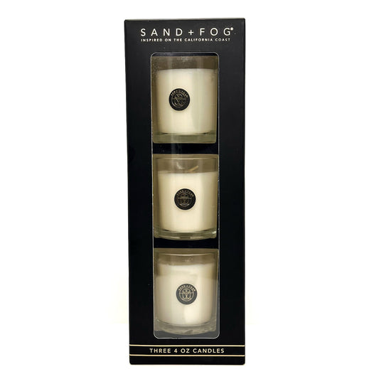 Three 4 oz candles in a black box with 'Sand + Fog' branding.