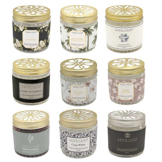 SAND+FOOD Odour Neutralising Gel Beads jars arranged in a 3x3 grid on a white background, each with a gold lid and different label scents and designs.