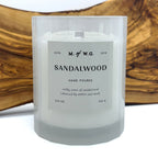 Makers of Wax Goods Sandalwood candle with a label on a wooden surface