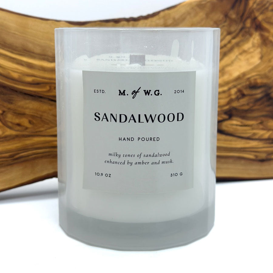 Makers of Wax Goods Sandalwood candle with a label on a wooden surface