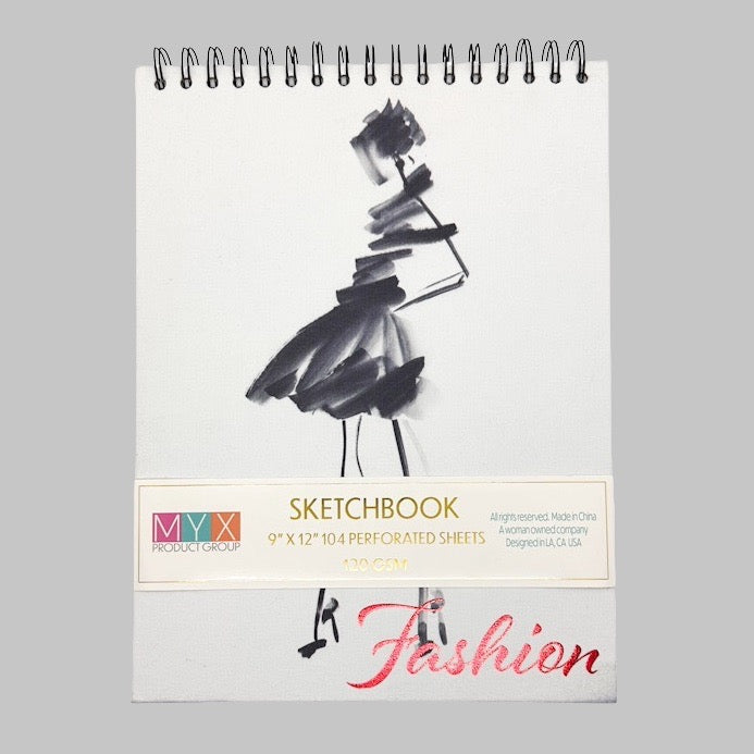 Sketchbook with fashion design on cover against a grey background