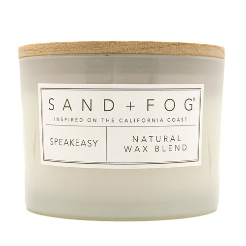 Speakeasy candle with 'Sand + Fog' label on a white background