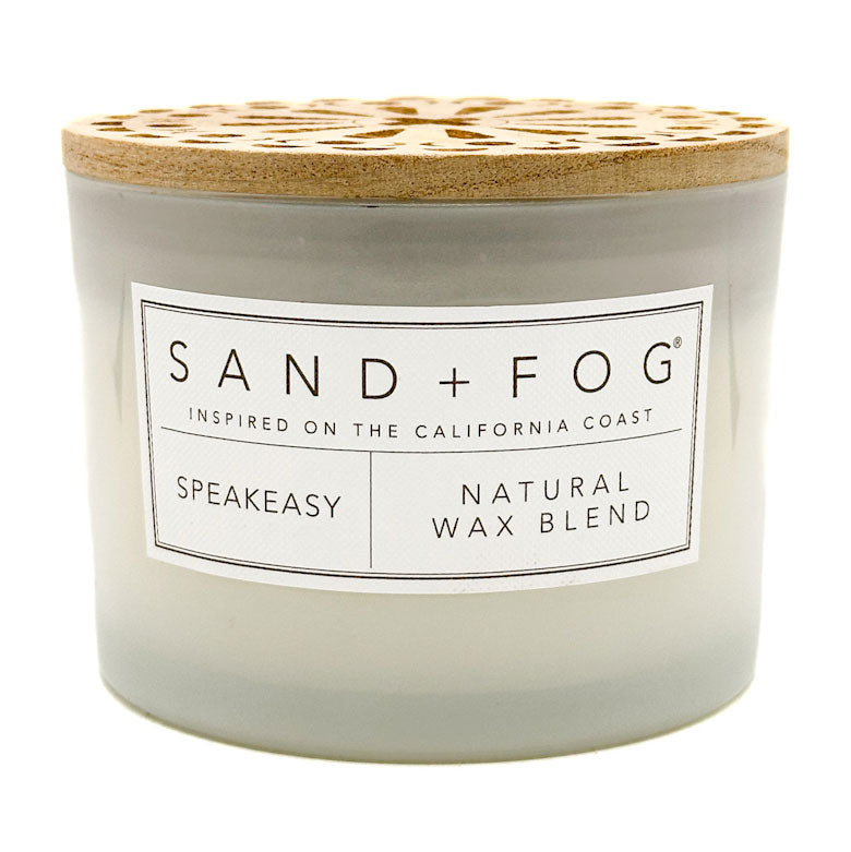 Speakeasy candle with wooden lid and 'Sand + Fog' label on a white background
