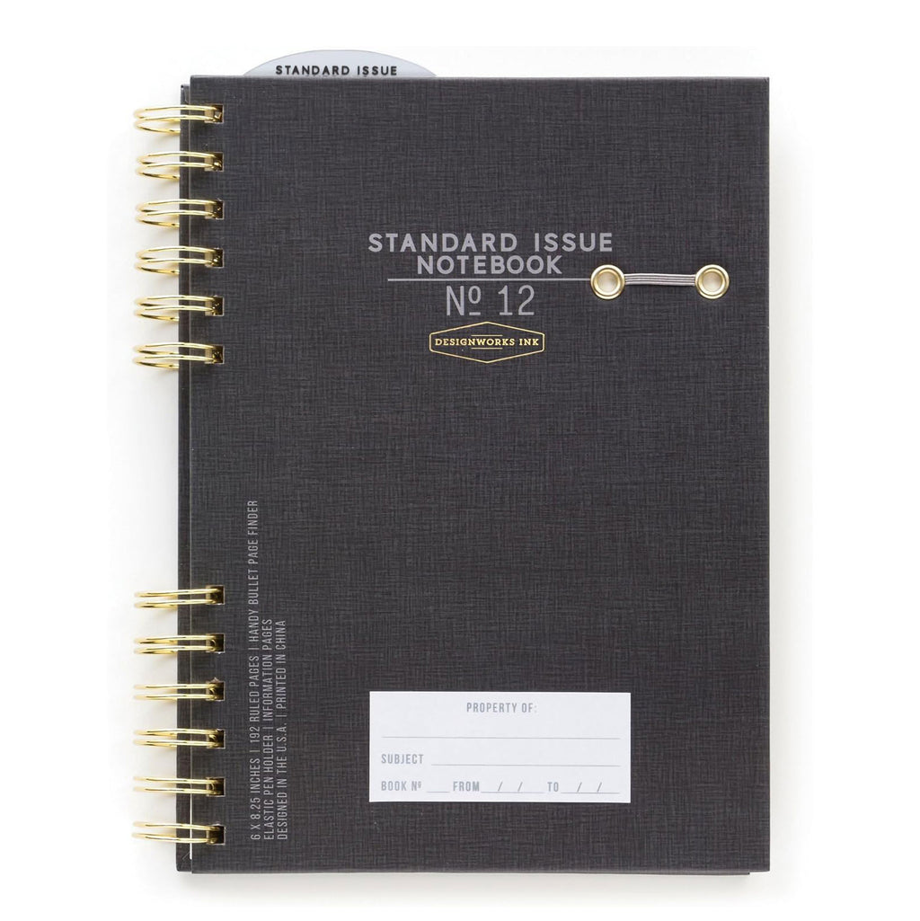 Standard Issue No12 black notebook with gold spiral binding on a white background