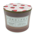Strawberry Mimosa candle with strawberry patterned lid and 'Sand + Fog' label on a white background