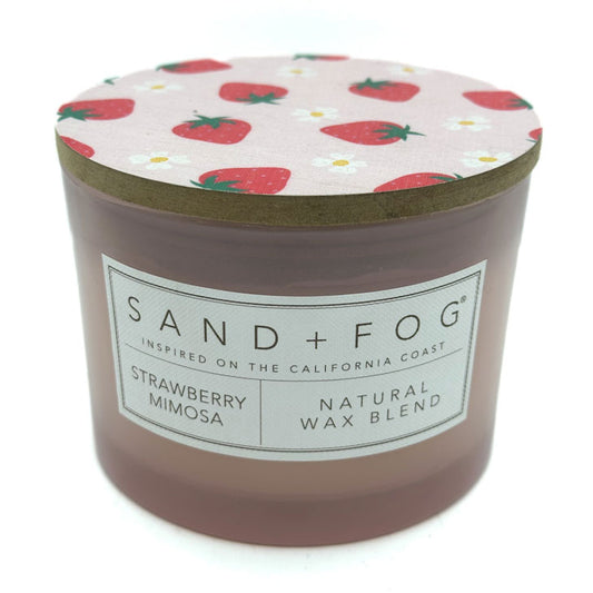 Strawberry Mimosa candle with strawberry patterned lid and 'Sand + Fog' label on a white background