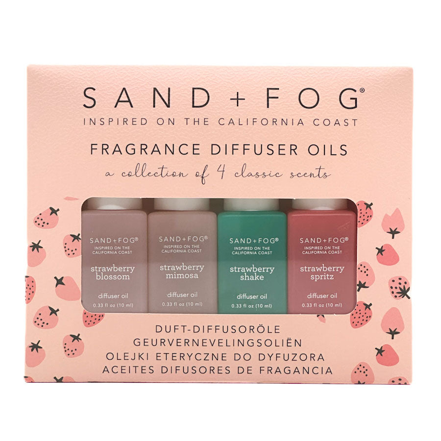 Sand + Fog fragrance diffuser oils set on a pink packaging with strawberry design