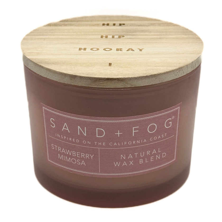 Strawberry Mimosa candle with wooden lid labeled 'Sand + Fog' on a white background