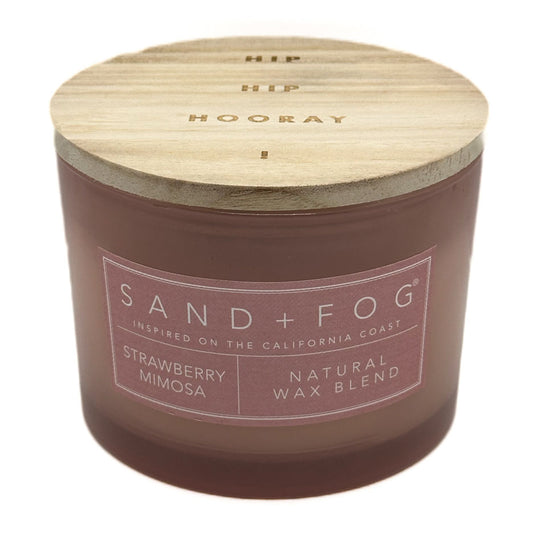 Strawberry Mimosa candle with wooden lid labeled 'Sand + Fog' on a white background
