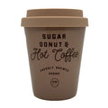 Sugar Donut & Hot Coffee scented candle by dw home in a brown coffee cup with text on a white background