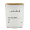 White candle with a wooden lid labeled 'SAND + FOG Tahitian Vanilla Candle' on a white background