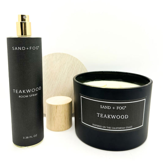 Teakwood room spray and candle by Sand + Fog on a white background