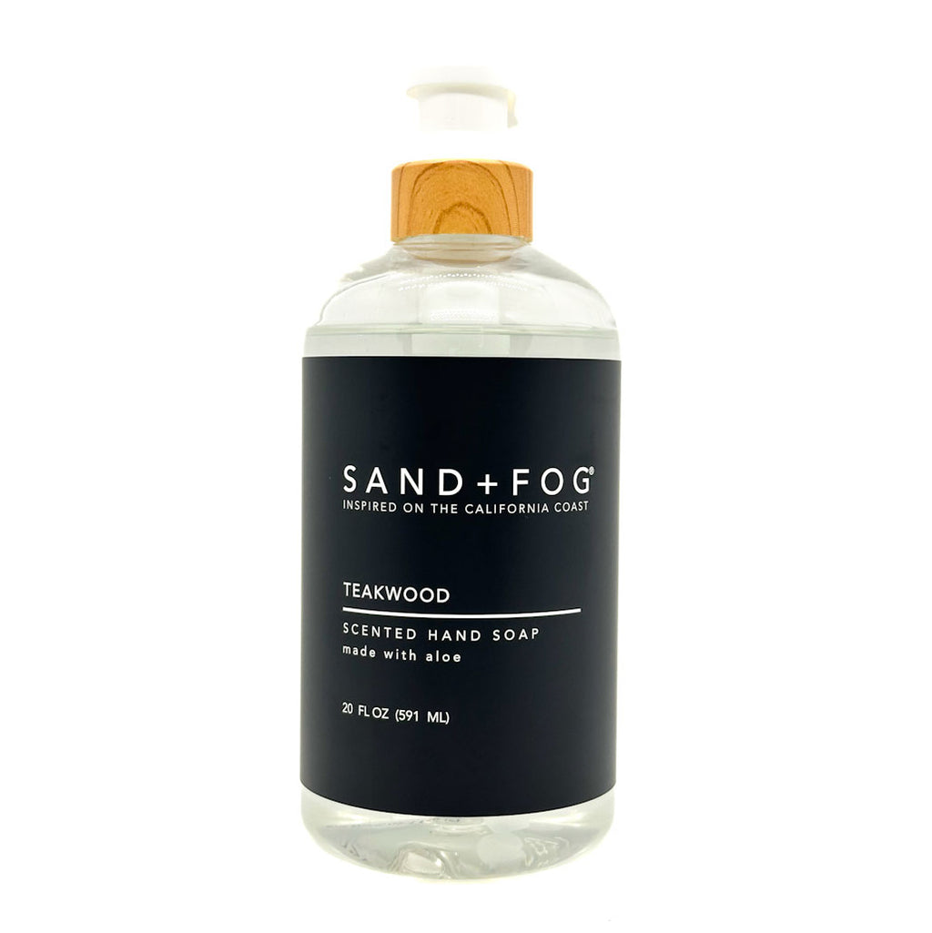 Teakwood clear bottle hand soap with a black label featuring 'Sand + Fog' on a white background.