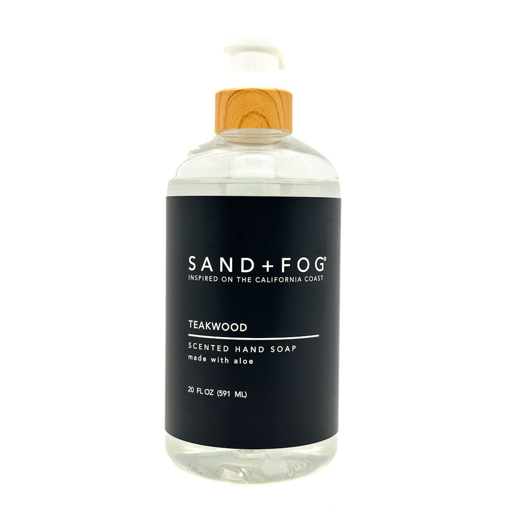Teakwood clear bottle hand soap with a black label featuring 'Sand + Fog' on a white background.