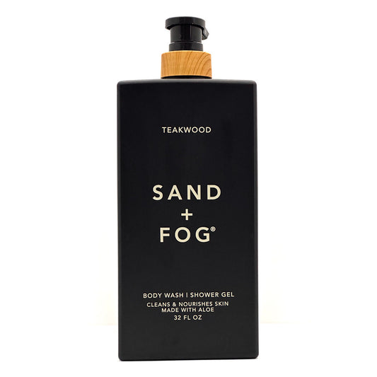 A 12 fl oz black bottle of Sand + Fog Teakwood body wash and shower gel with a light wood-textured collar and gold lettering, shown on a white background.