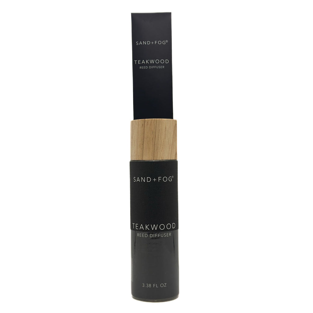 Black and wood Teakwood reed diffuser bottle labeled 'Sand + Fog' on a white background