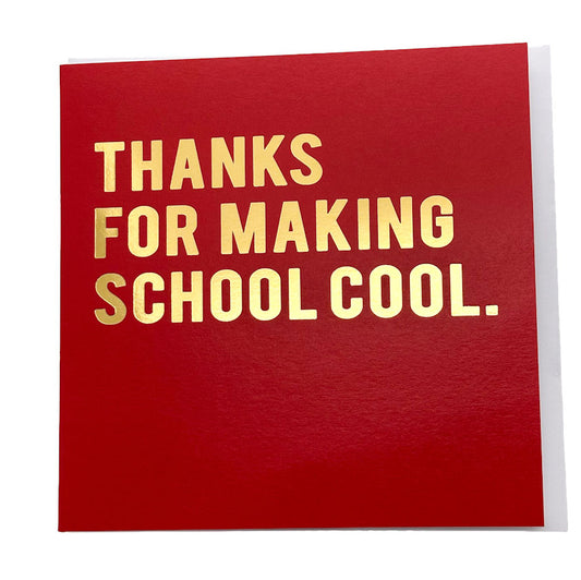 A square red greeting card with metallic gold foil text that reads 'THANKS FOR MAKING SCHOOL COOL.' on a clean white background.