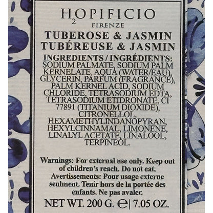 Back label of a Hopificio Firenze tuberosse & jasmin fragrance soap bar, showing ingredients, warnings, and net weight on a beige background with blue floral border details.