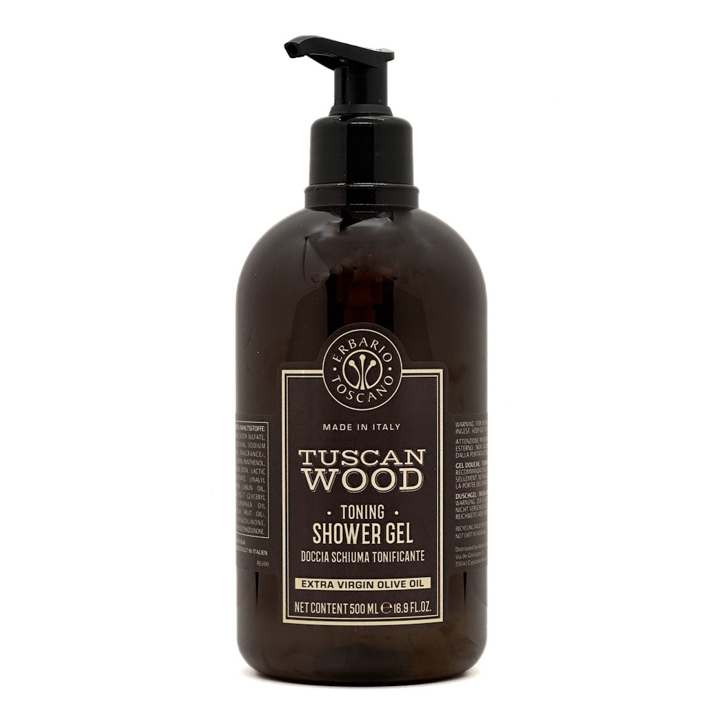 A 500 mL pump bottle of Tuscan Wood Shower Gel by Erbario Toscano, made from amber-brown translucent plastic with a black pump dispenser and a black label with gold text.