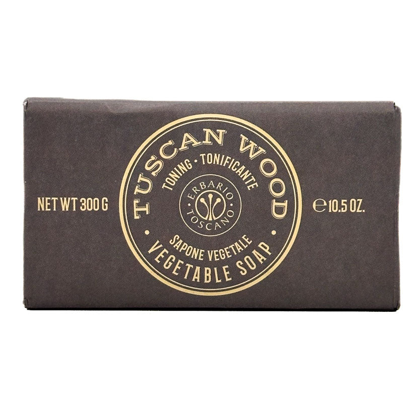 Bar of Tuscan Wood soap with brown packaging and gold text on a white background