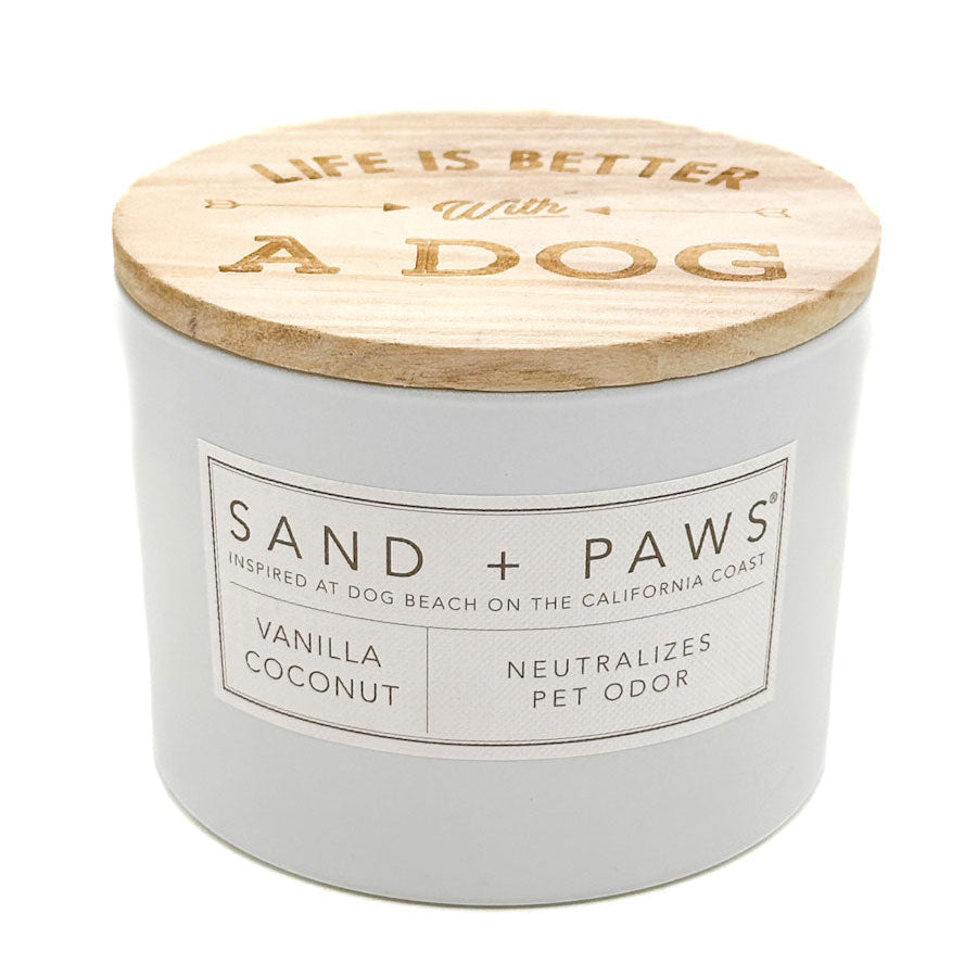 Vanilla Coconut candle with wooden lid labeled 'Life is Better with a Dog' by Sand + Paws on a white background