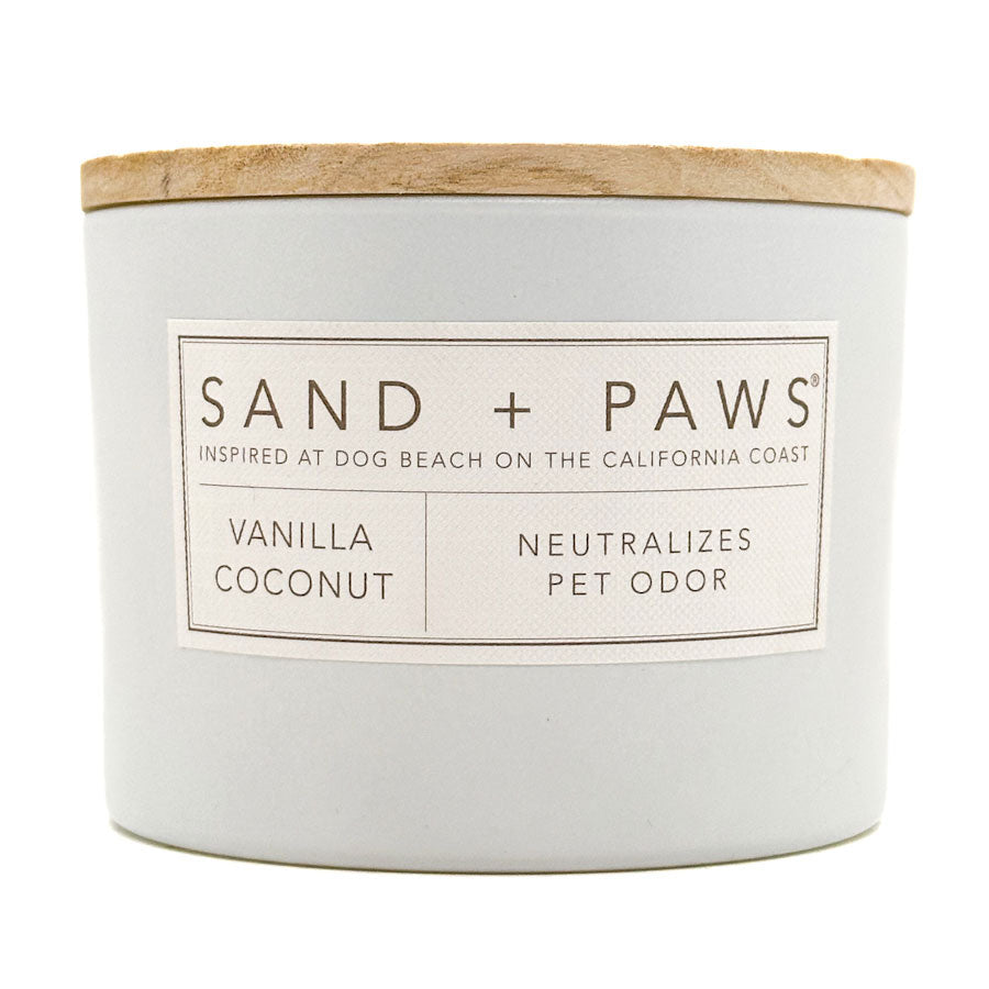 Vanilla Coconut candle with 'Sand + Paws' label on a white background