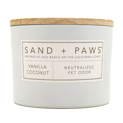 Vanilla Coconut candle with 'Sand + Paws' label on a white background