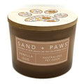 Vanilla Oud candle with 'Sand + Paws' branding on a white background