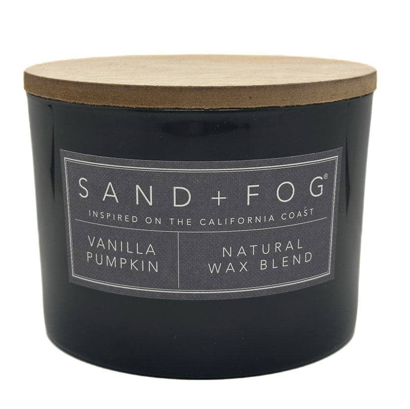 Grey Vanilla Pumpkin candle with a wooden lid labeled 'Sand + Fog' on a white background