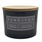 Grey Vanilla Pumpkin candle with a wooden lid labeled 'Sand + Fog' on a white background