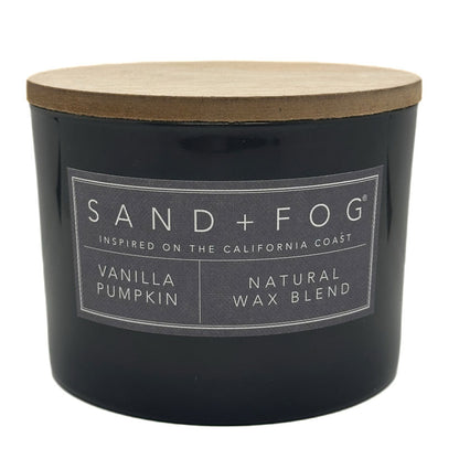 Grey Vanilla Pumpkin candle with a wooden lid labeled 'Sand + Fog' on a white background