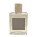 SAND + FOG Clear glass Vanilla Sandalwood room spray bottle with wooden top on a white background